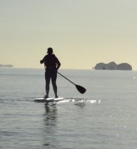 silhouette of Megan learning to SUP